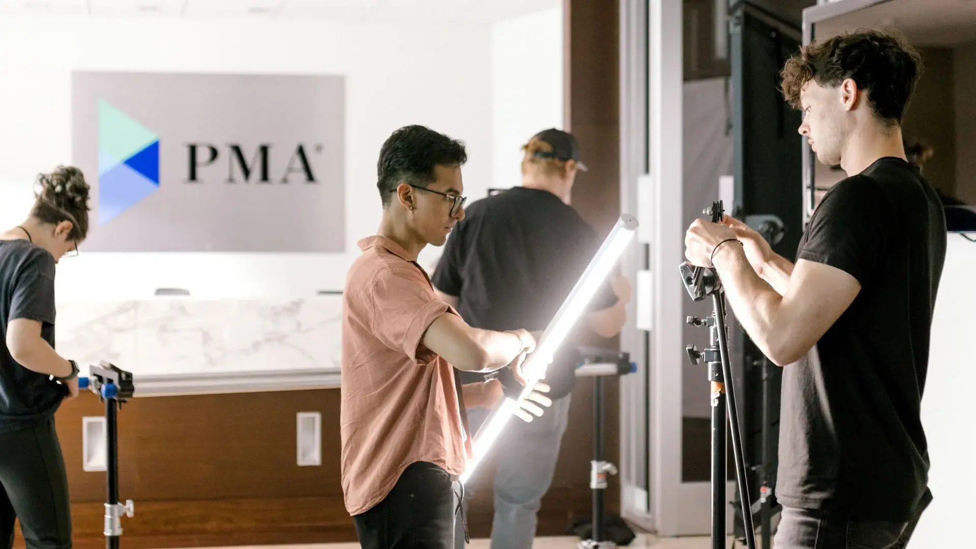 gaffer setting up lighting equiptment