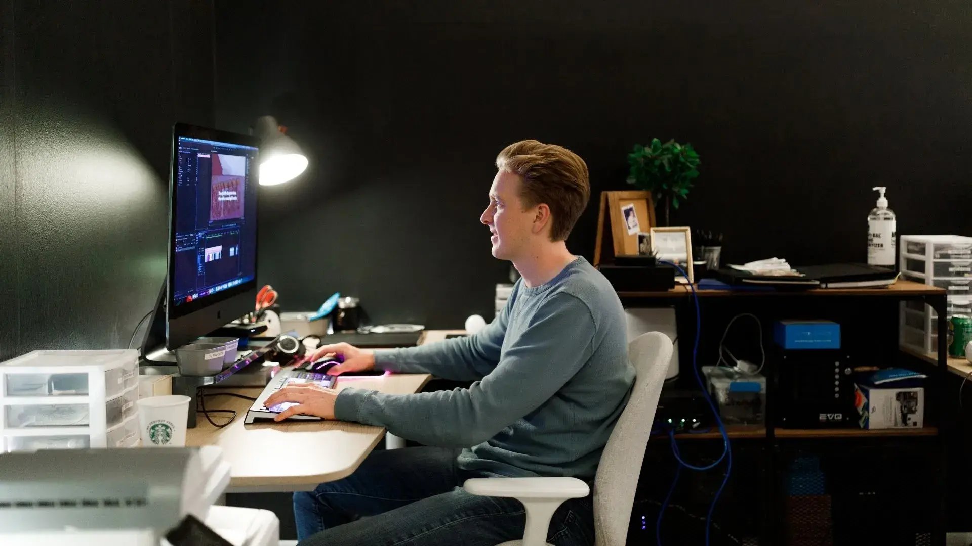 video editor working at computer