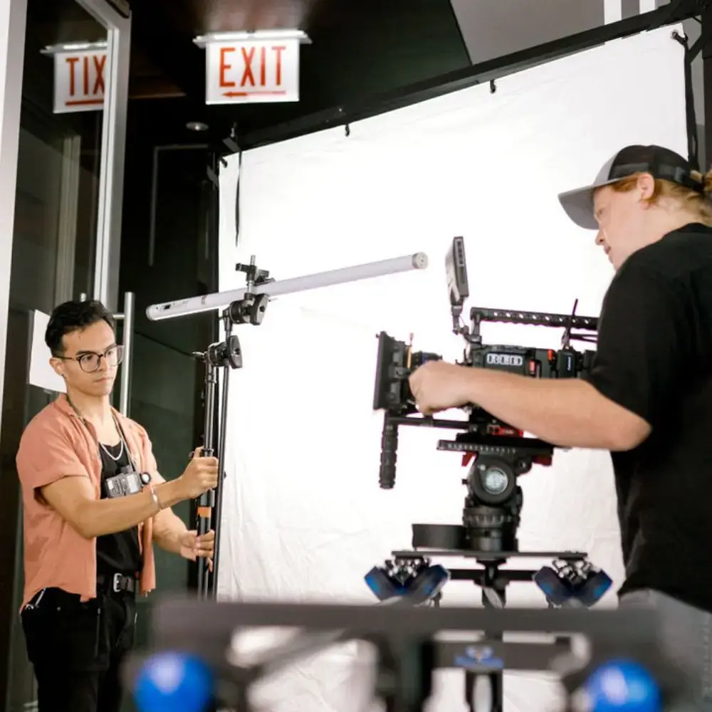 gaffer and dp setting up equipment
