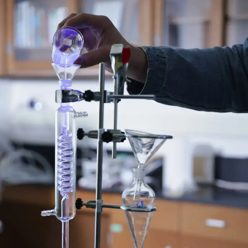 solution being poured into beaker