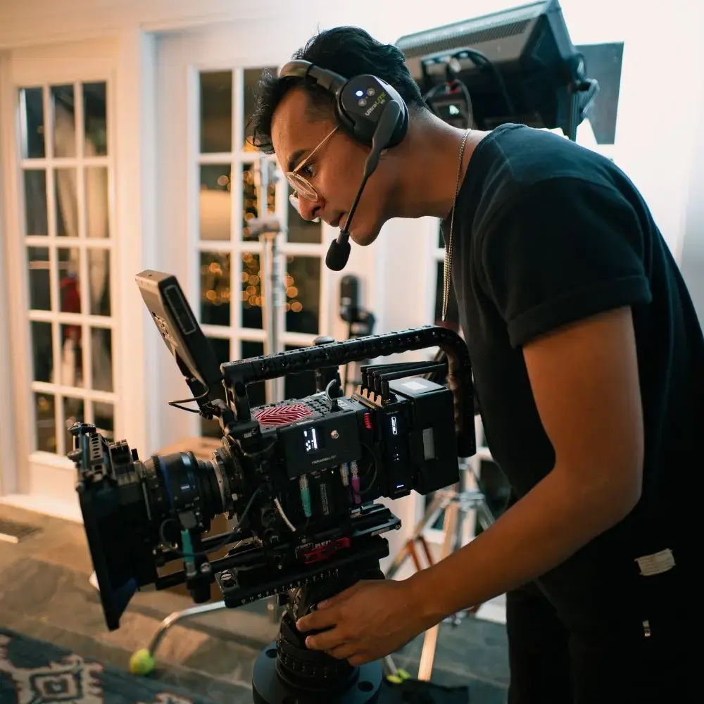 camera operator filming with cinematic camera
